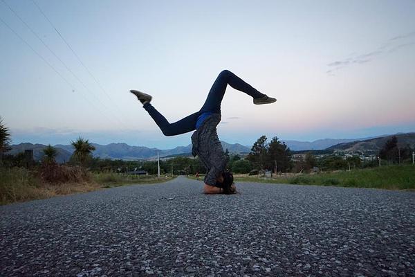 Yoga headstand pose in the middle of the road