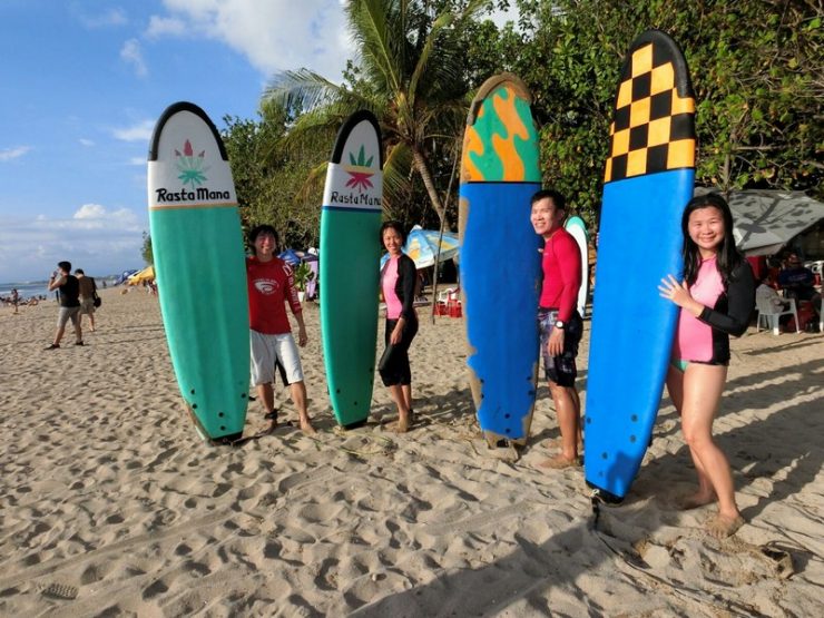 outdoor adventures in Bali - Kuta Beach at Bali Indonesia | We and our big colourful boards. Behind those smiles are exhausted aching bodies and nose and mouth full of saltwater