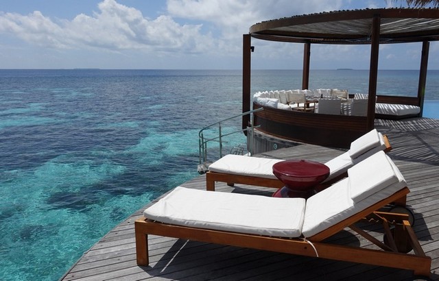 Veranda of the over water bungalow at W Maldives, overlooking the stunning coral reefs and blue clear ocean