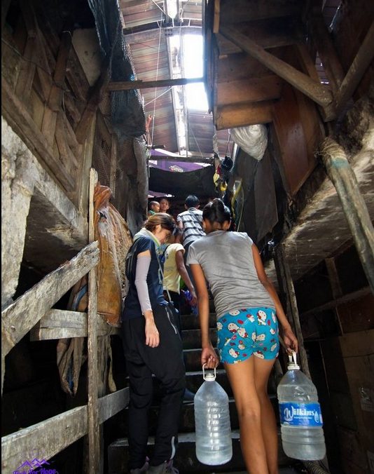 Carrying water back to the slums