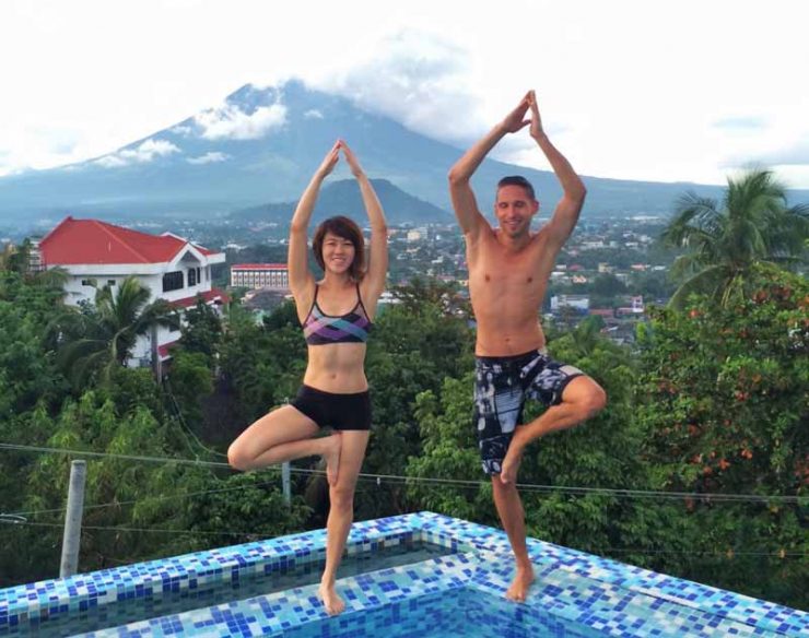 Doing yoga moves at The Oriental Legazpi, can you see the volcano at the back?