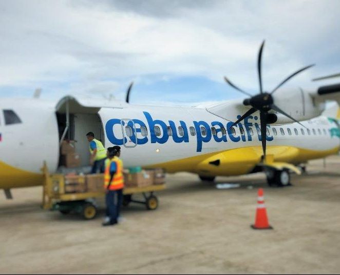 Our cebu pacific propeller plane unloading our luggage