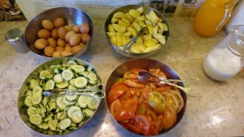 Big bowls of freshly cut veggies and fruit