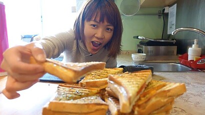 Greedy shot of me grabbing those freshly made toasties with tomato and cheese at Good Morning Hostel