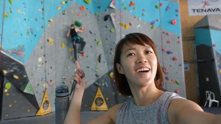 Warm up on an easy auto belay routes in rock domain climbing gym Bangkok
