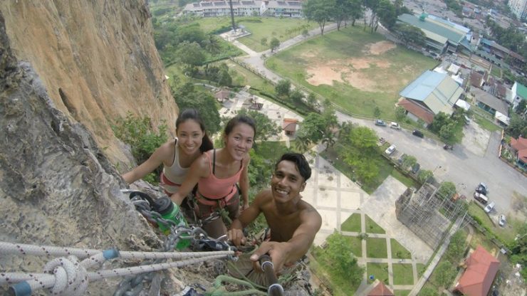 Batu Caves Rock Climbing, hanging from a multi pitch point on the wall. What a great view!