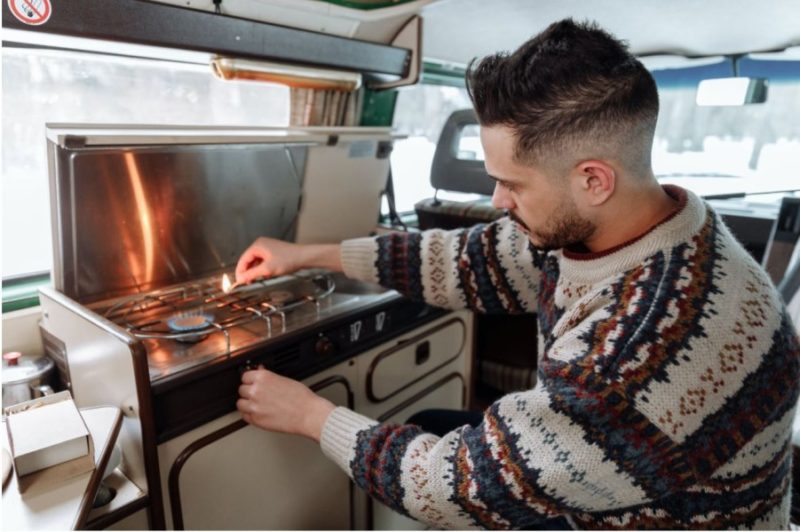 lighting a stove | Road Trip VS Campervanning - Which is Better
