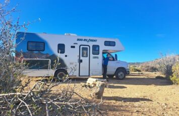 parked white rv campervan in desert