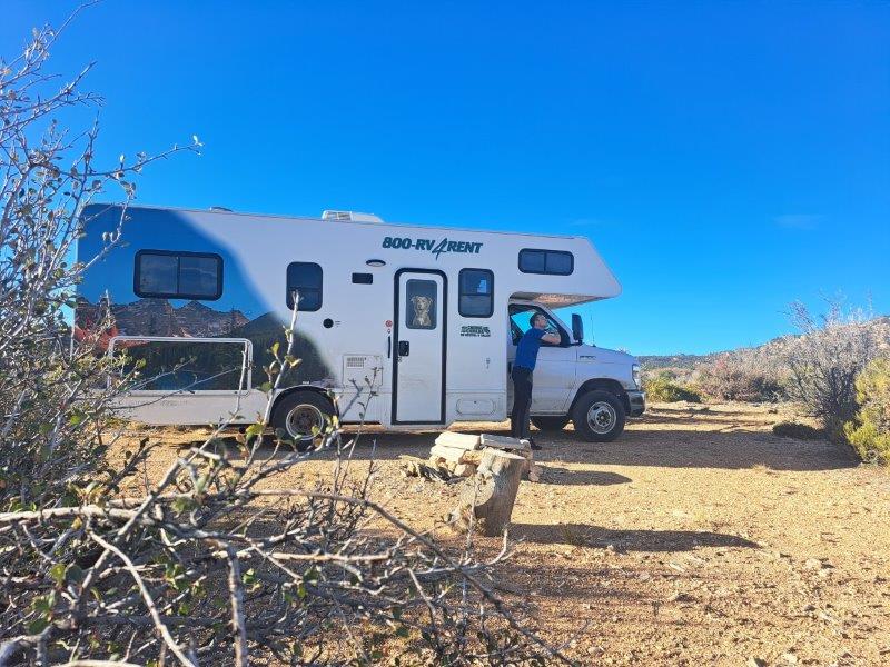parked white rv campervan in desert