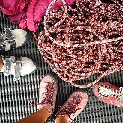 climbing shoes and climbing rope og pink climbing shoes and climbing rope standing near climbing rope with climbing shoes on