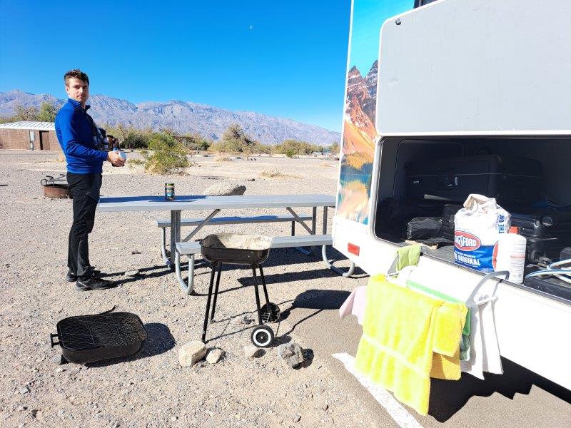 resting setup outside rv setting up drying rack and camping site beside rv campervan