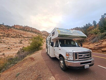 rv along sandy trail rv along sandy desert trail near canyon and hills