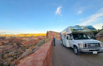 parked rv campervan cliff overlooking desert scenery