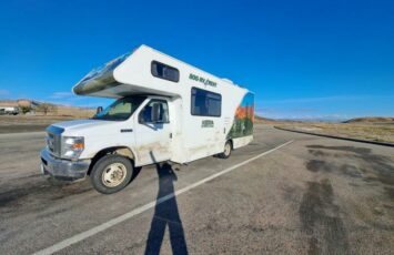 parked white rv campervan outdoor stretch of highway road