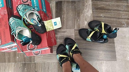 trying Scarpa climbing shoes in a store_og