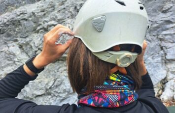 adjusting white climbing helmet