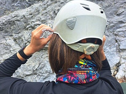 adjusting white climbing helmet