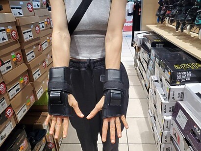 both hands back view of black wrist guards both hands back view of black wrist guards