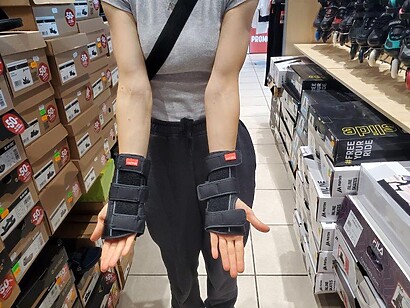 both hands front view of black wrist guards both hands front view of black wrist guards