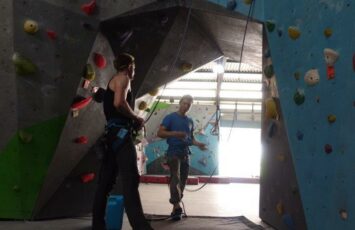 instructor explaining safety rules inside climbing gym