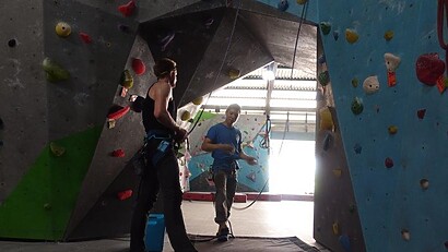 instructor explaining safety rules inside climbing gym instructor explaining safety rules inside climbing gym