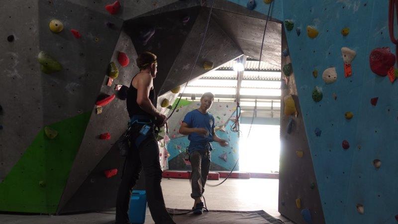 instructor explaining safety rules inside climbing gym