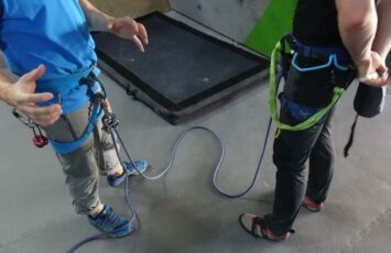 preparing for climbing with instructer and harness put on