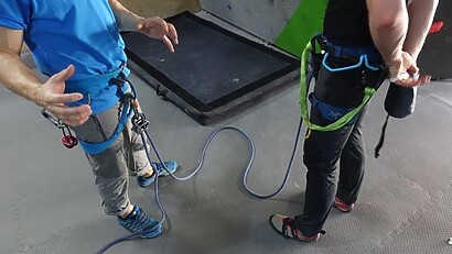 preparing for climbing with instructer and harness put on