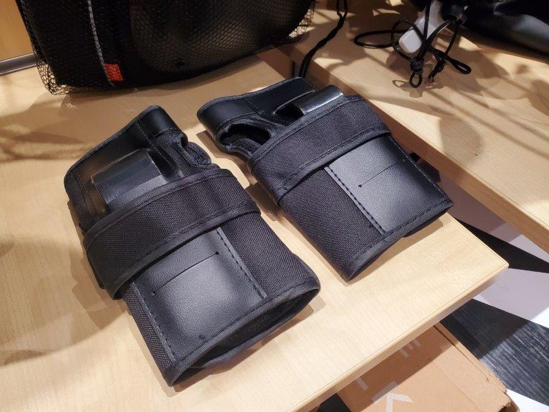wrist guards on display on wooden shelf