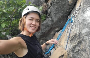 selfie while rock climbing in the forest with blue anchor sling